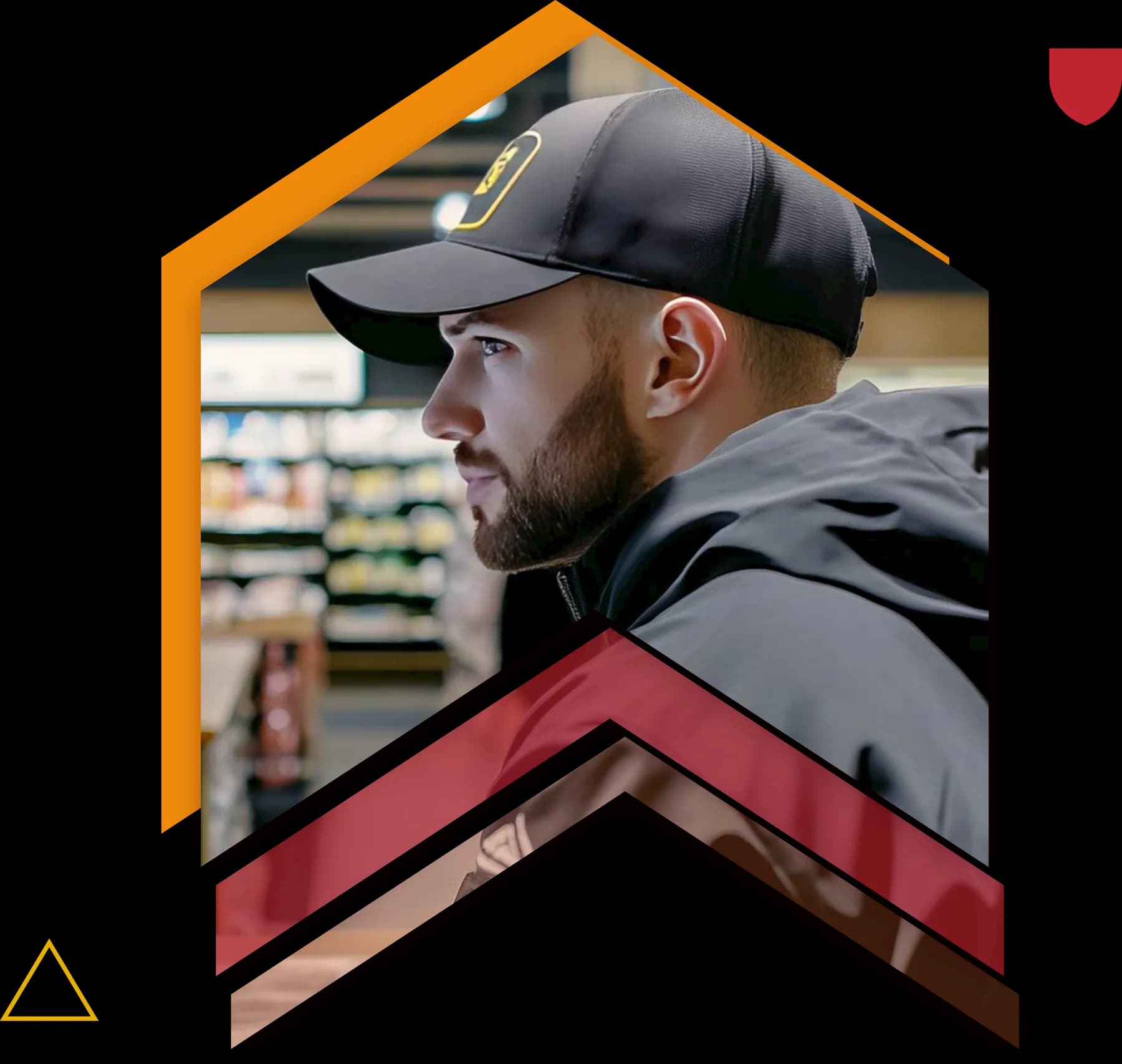 A security officer in a cap on a shop floor, framed in an orange peak above crimson chevrons.
